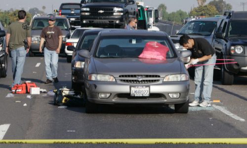 Investigators gather evidence at the scene of a gun battle on the 91 freeway between Brookhurst and Euclid, in Anaheim. June 22, 2008.