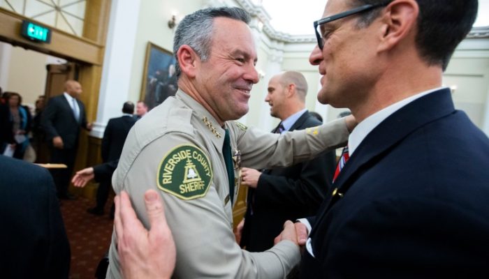 Riverside County Sheriff Chad Bianco and Riverside County District Attorney Mike Hestrin exchange pleasantries