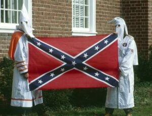 KKK holding CSA flag