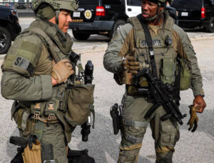 LASD deputy armed with vest and machine guns