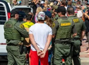 Orange County Sheriff's Department deputy sheriffs arresting man at the beach 2