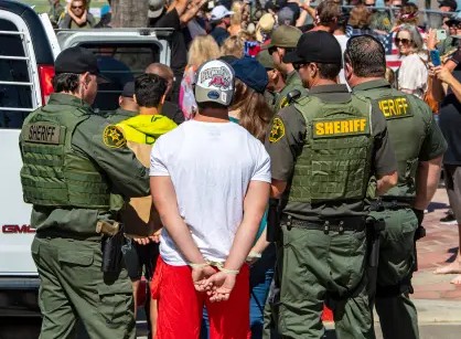 Orange County Sheriff's Department deputy sheriffs arresting man at the beach 2