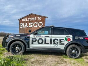 Wasco police cars and sign