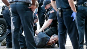 police proning man on ground